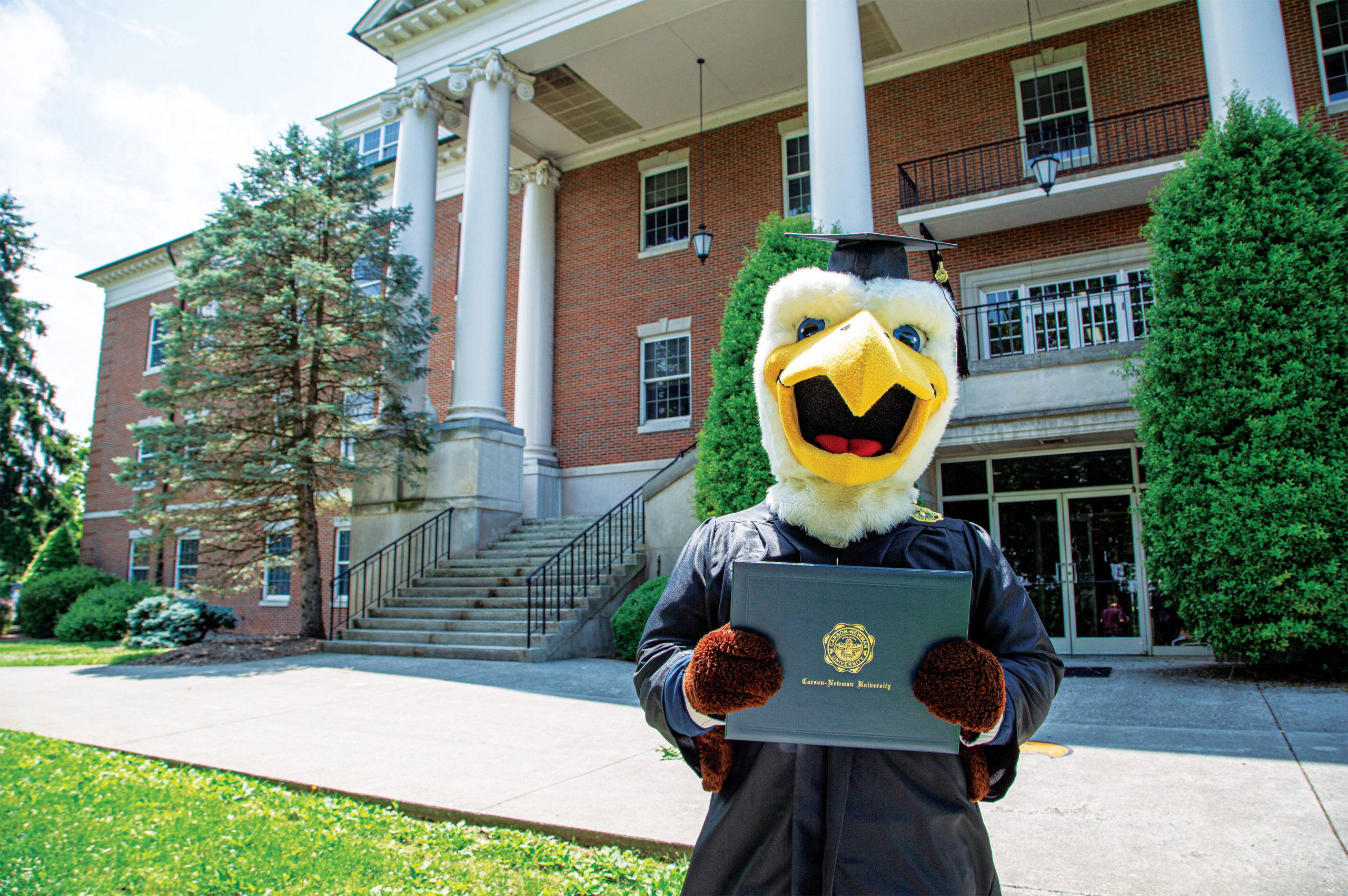 Talon holding a diploma